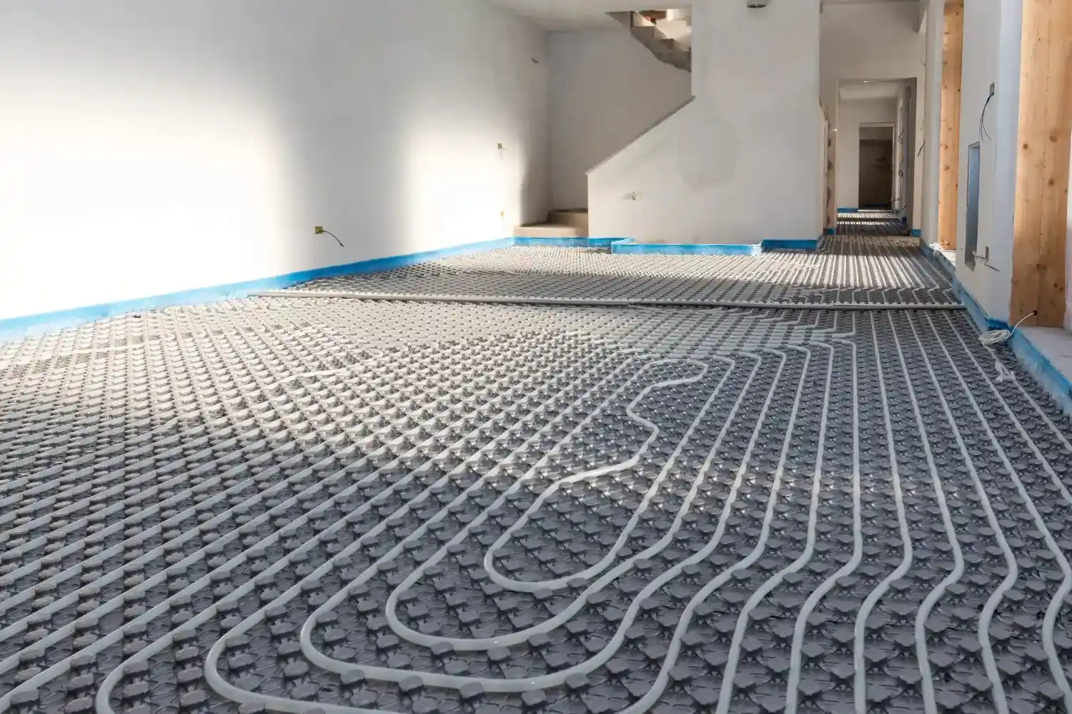Underfloor heating pipes installed in a room.