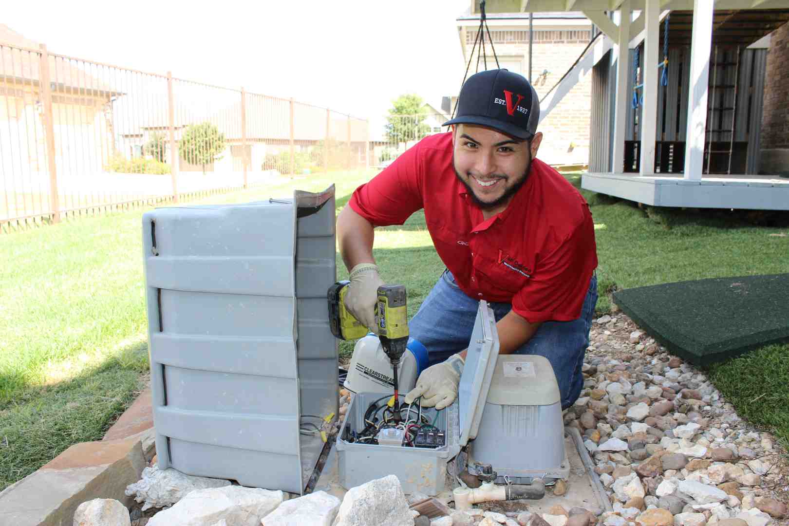 A professional technician inspecting an aerobic system component, wearing a clean uniform, emphasizing precision and expertise, using brand colors #fe0103, #ffffff, #000000 - aerobic system repair san antonio tx