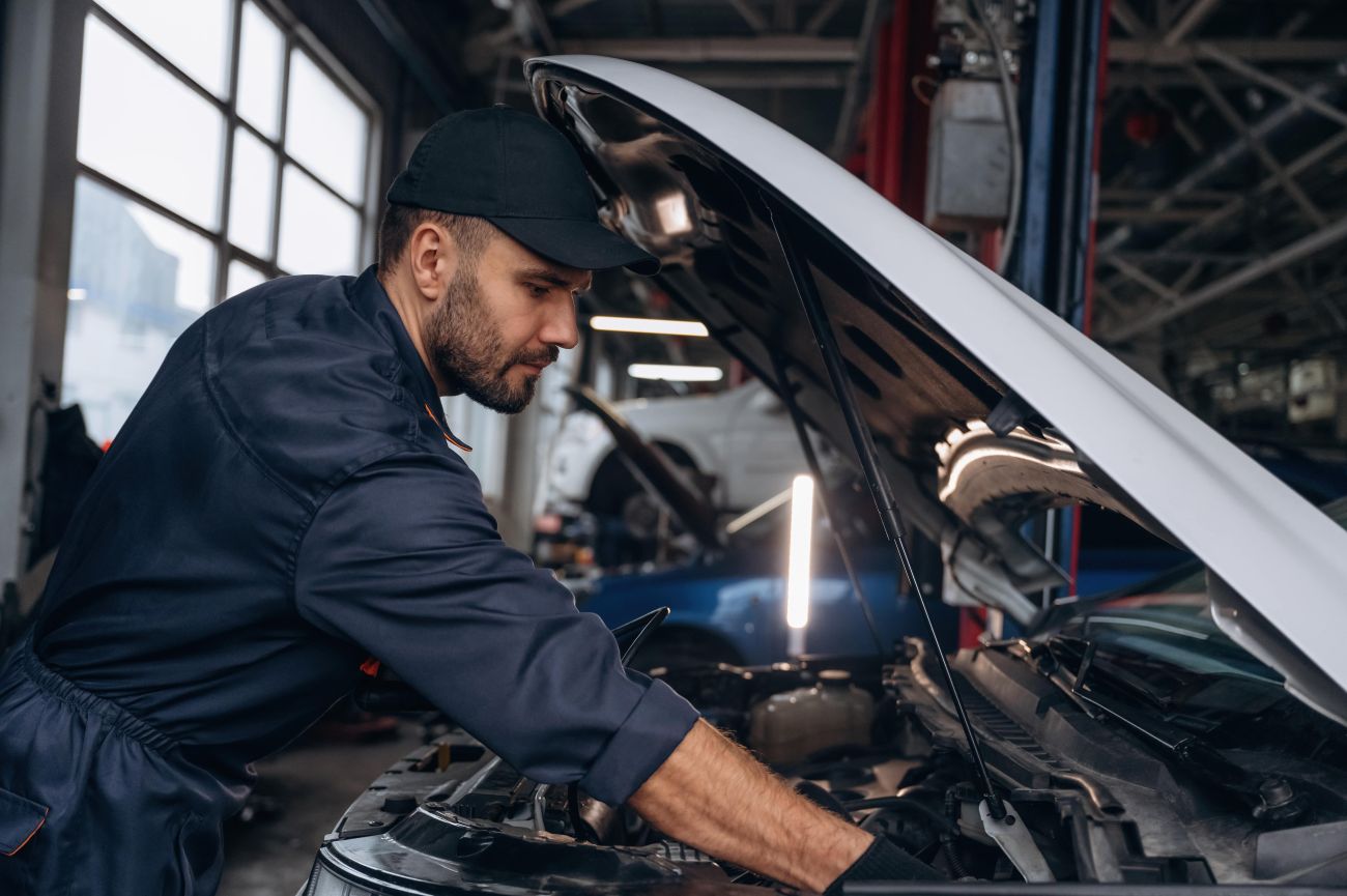 Mechanic performing seasonal vehicle maintenance on a car in Edmonton