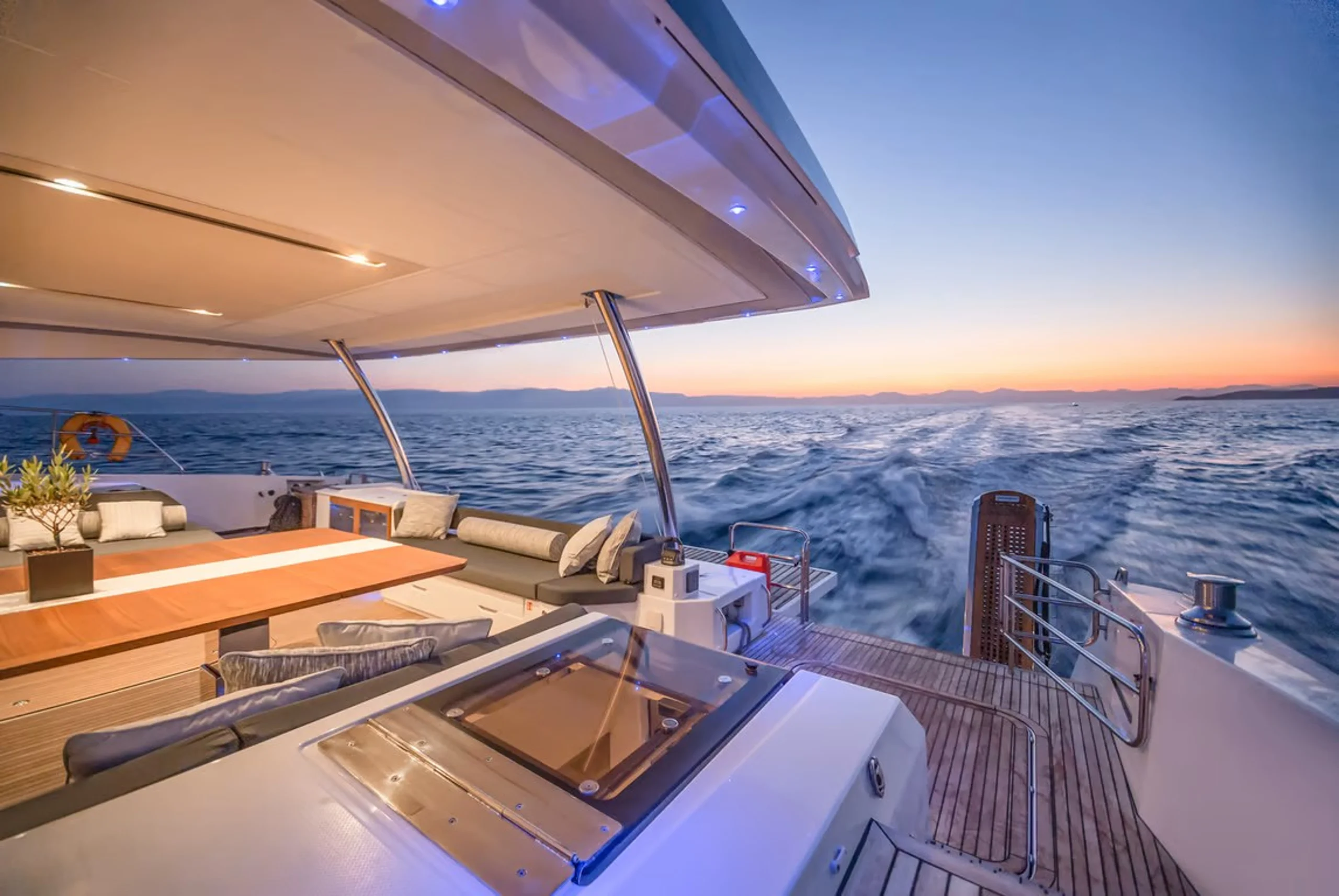 CORE - Fountaine Pajot 67 Power Catamaran aft deck under motor at sunset