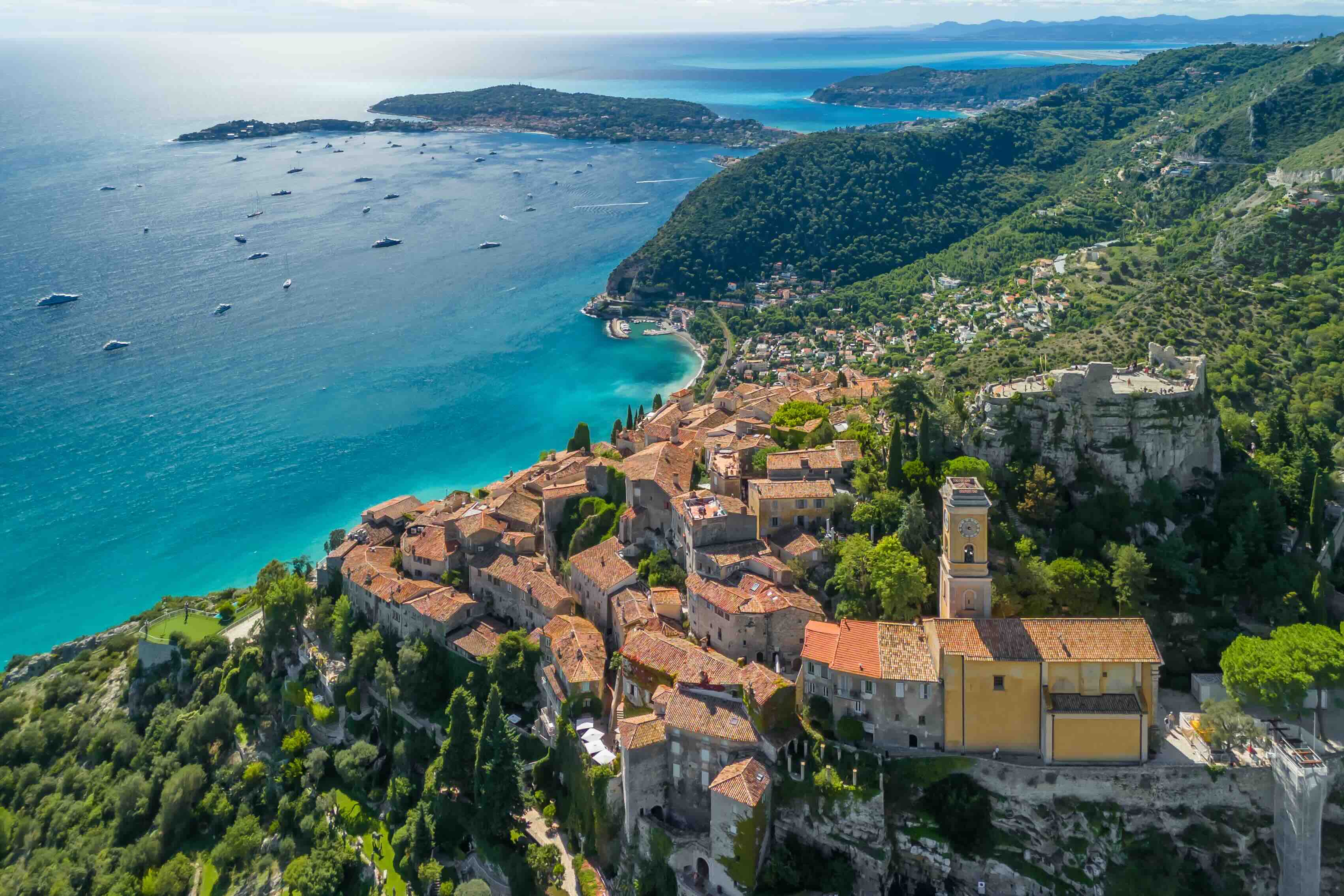 Aerial view of the medieval hilltop village of Eze, offering panoramic vistas of the French Riviera coastline.