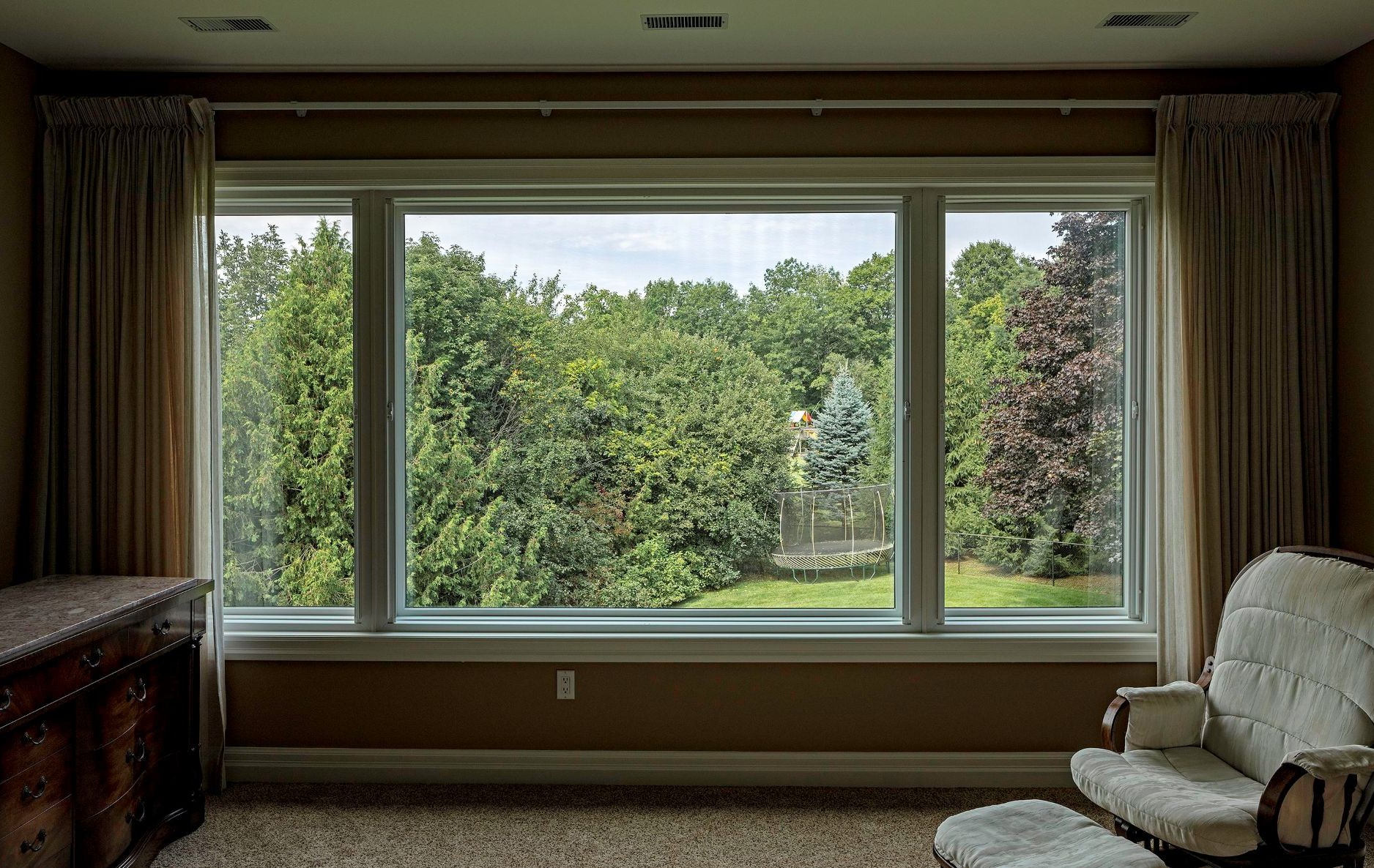 living room with sheer curtains as window coverings