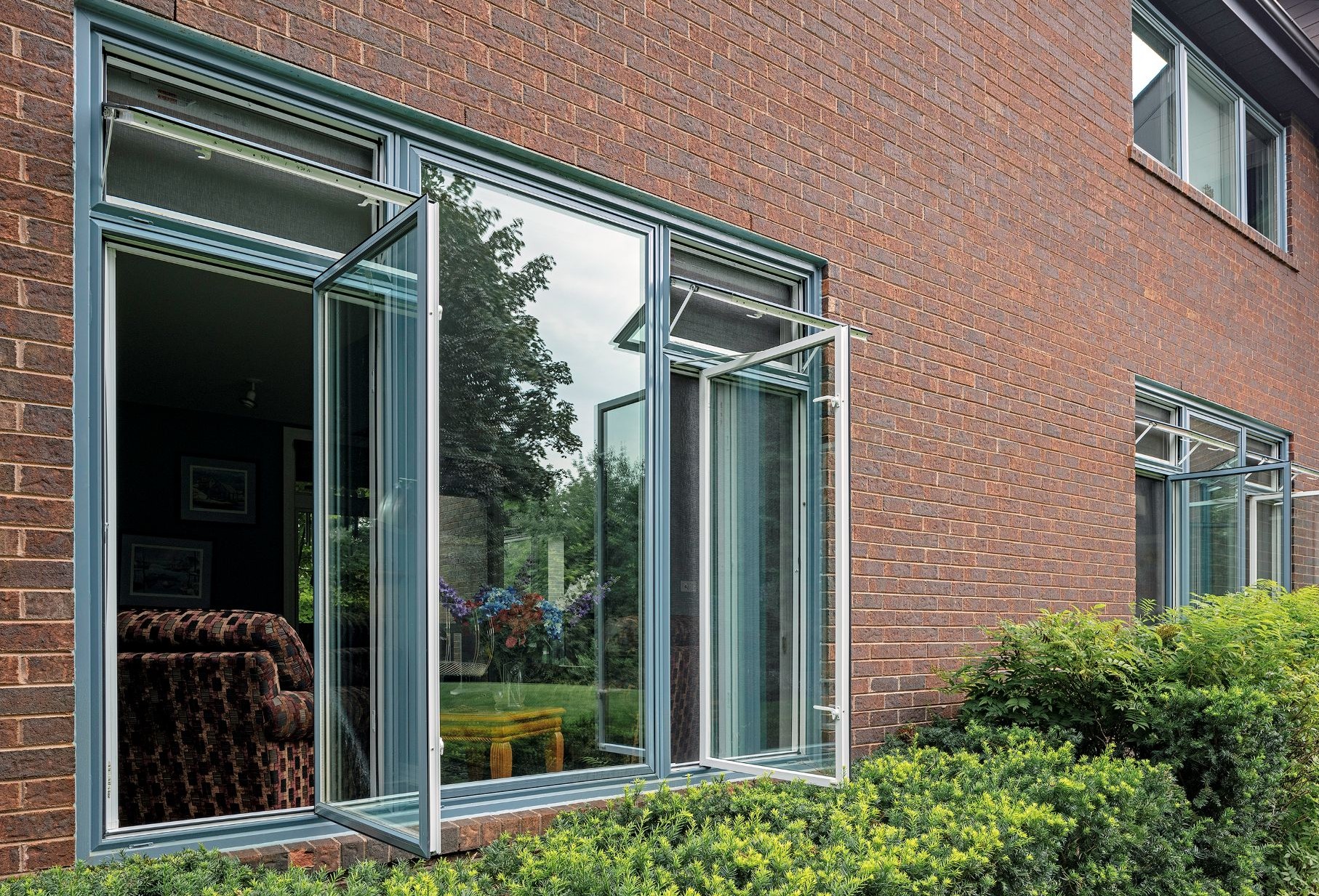 two casement windows with awning windows on top separated by a picture window
