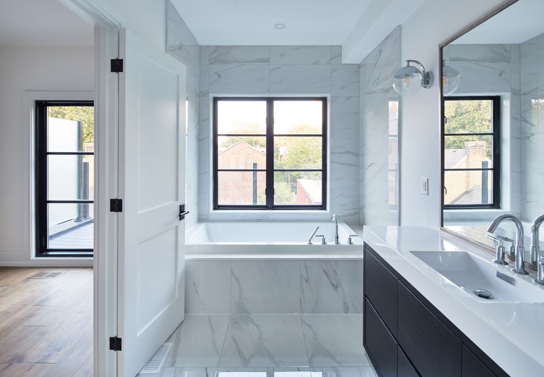 bathroom with aluminum composite black windows above the bathtub