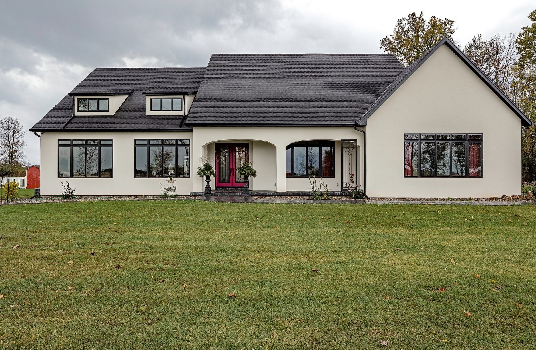 minimalist house with white siding and black windows