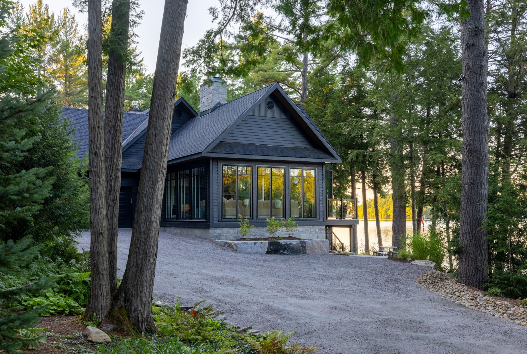 cottage house with dark siding and black windows