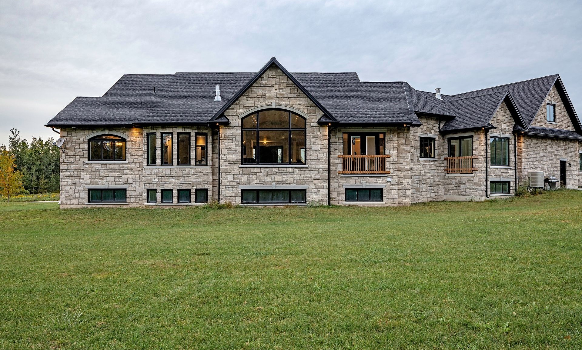 house with stone siding and black windows