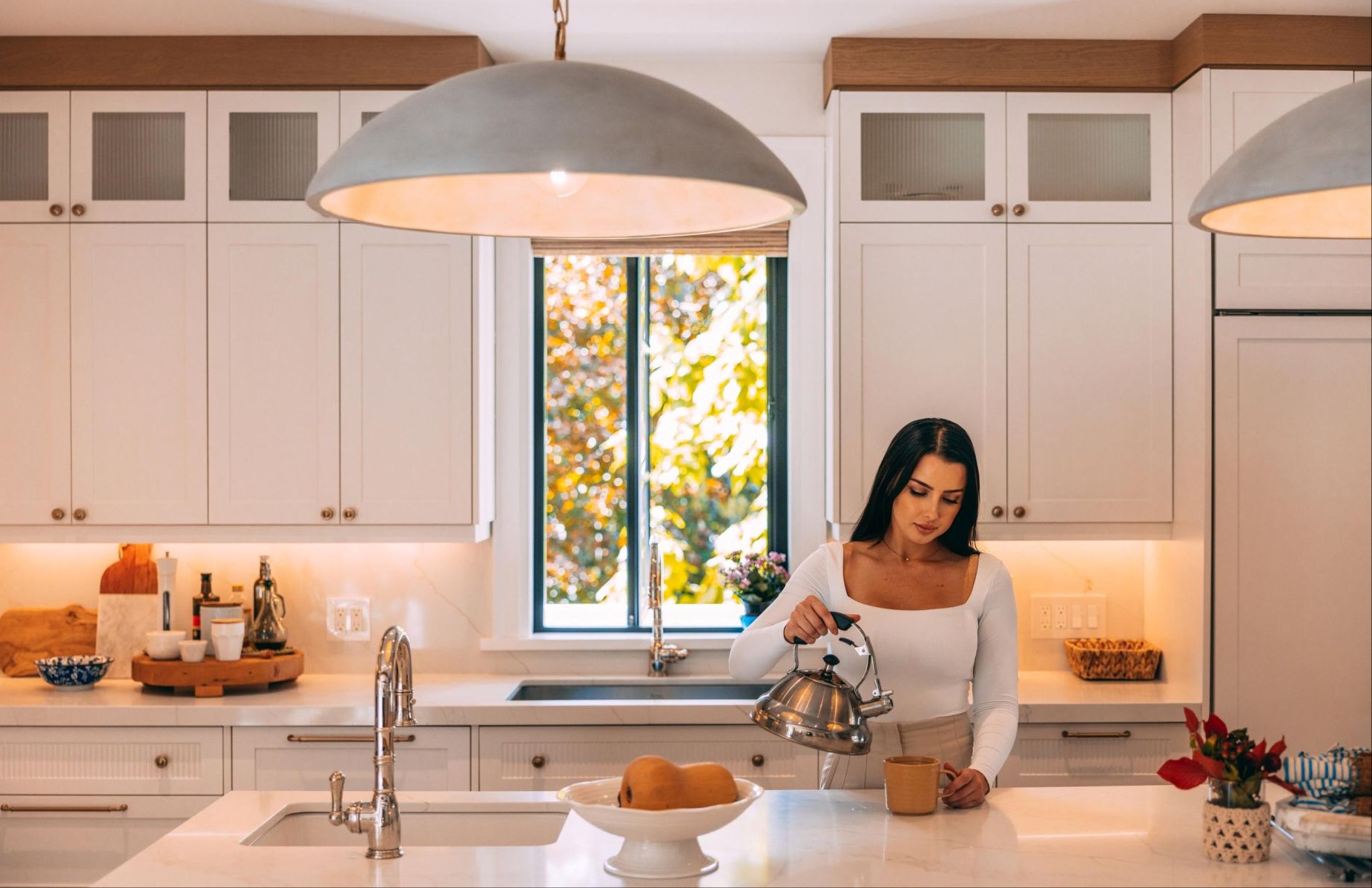 woman preparing tea in a newly remodeled kitchen