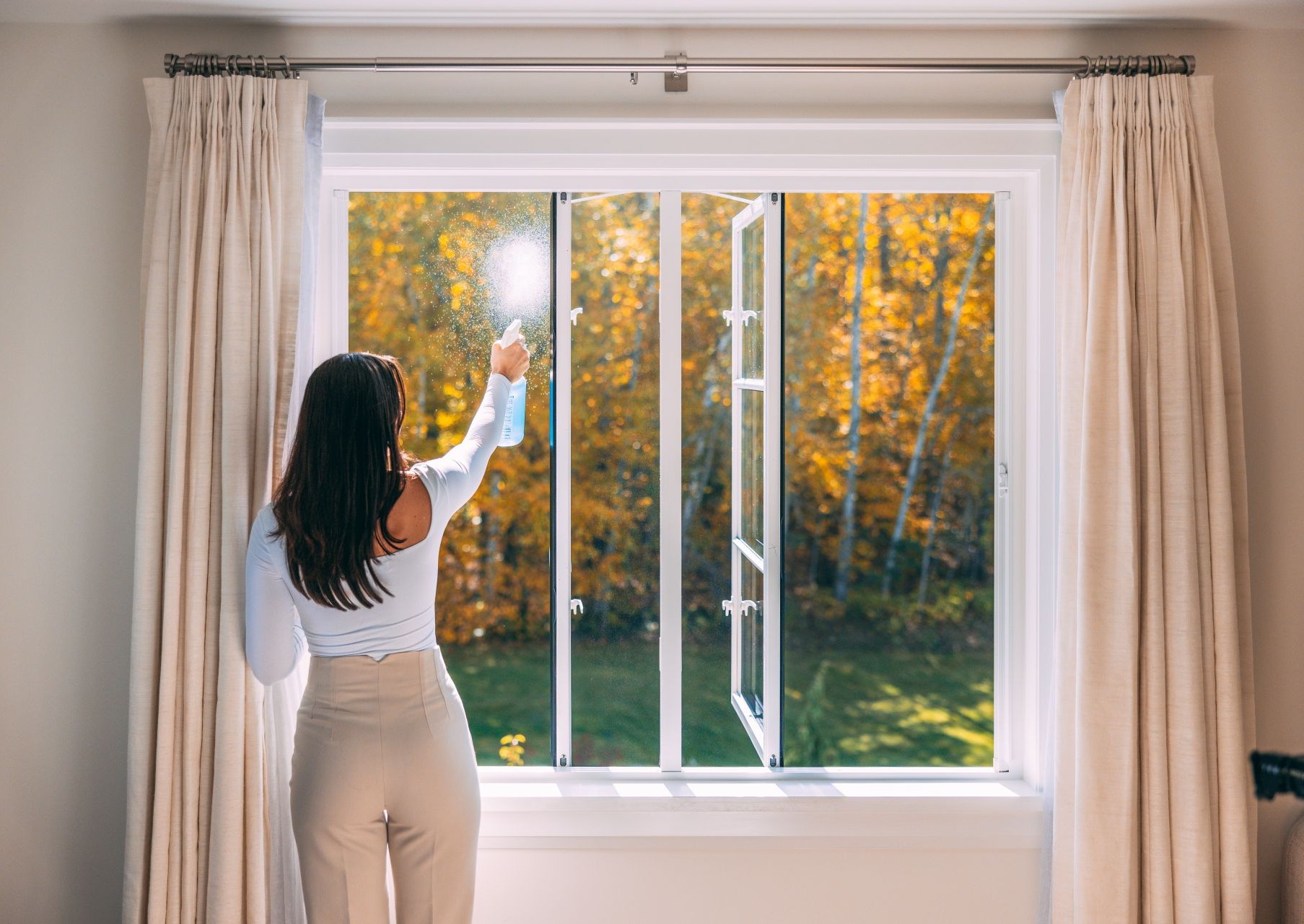 woman showing the best way to clean windows