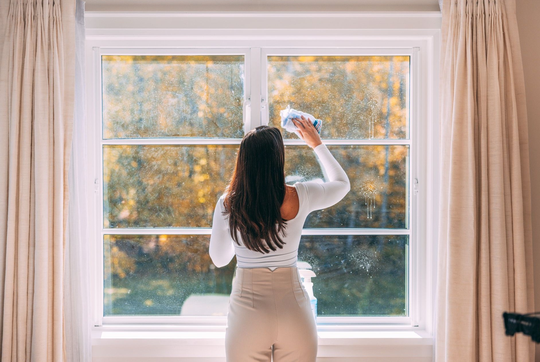 woman cleaning a window