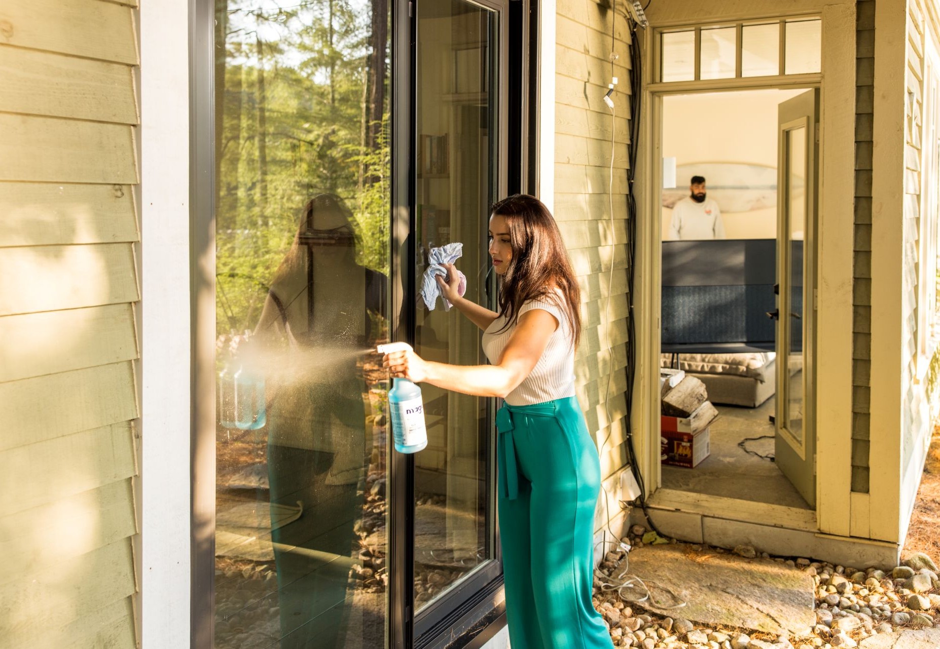 woman cleaning a large glass door