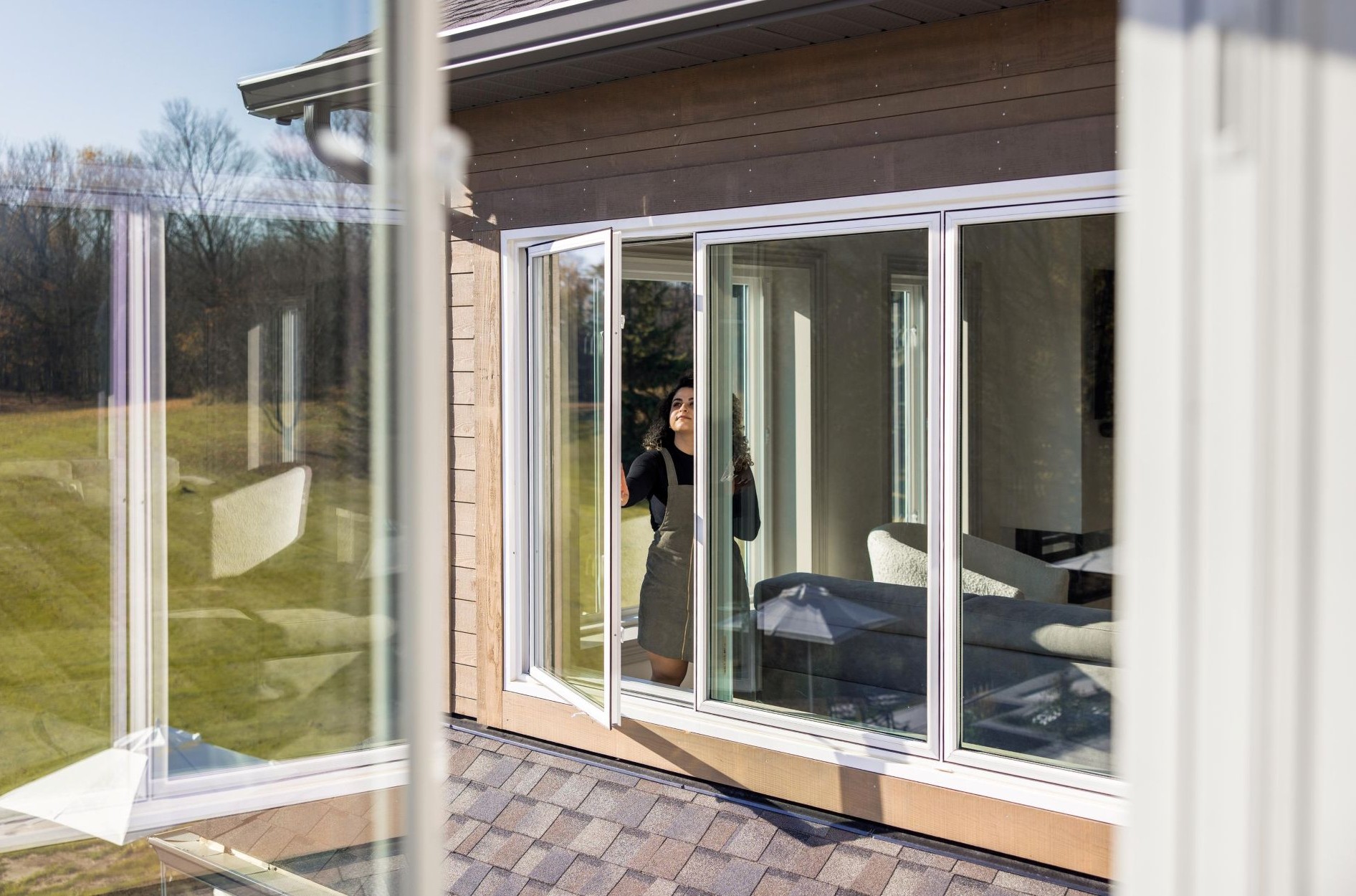 woman opening windows with weep holes