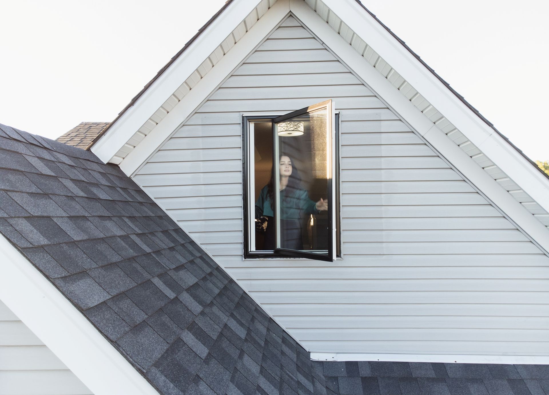 woman opening a newly replaced casement window