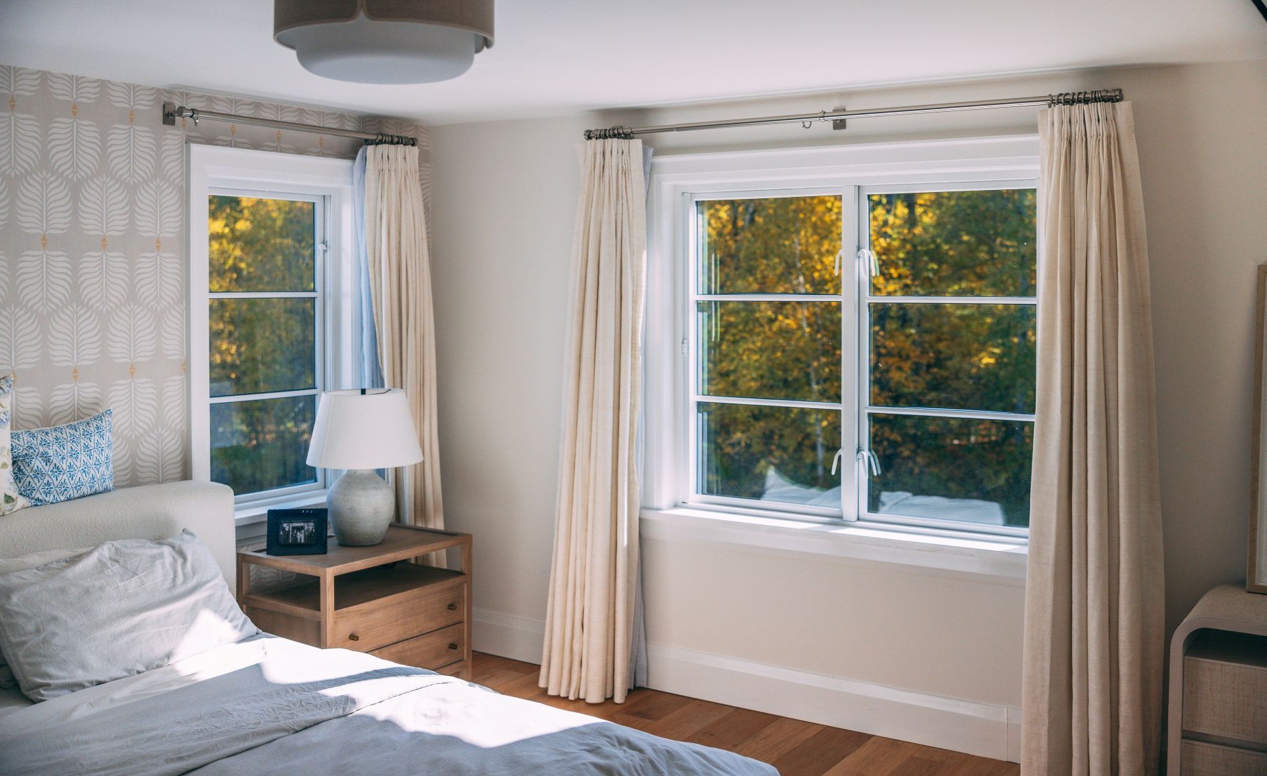bedroom windows with curtains as window treatments
