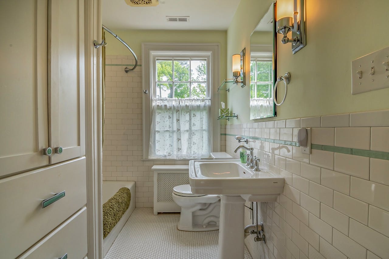 cafe curtains covering double-hung bathroom windows