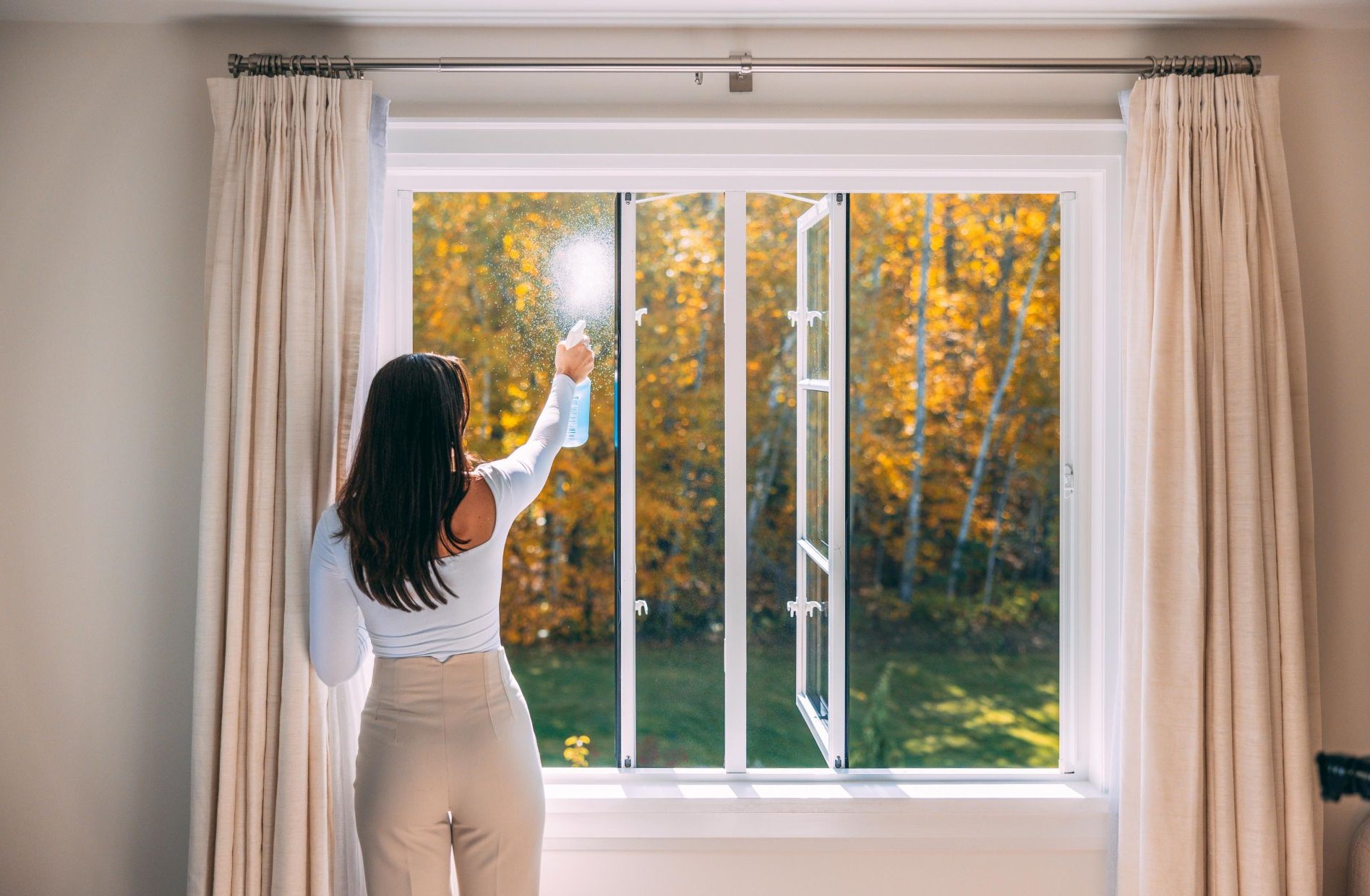woman cleaning a casement window