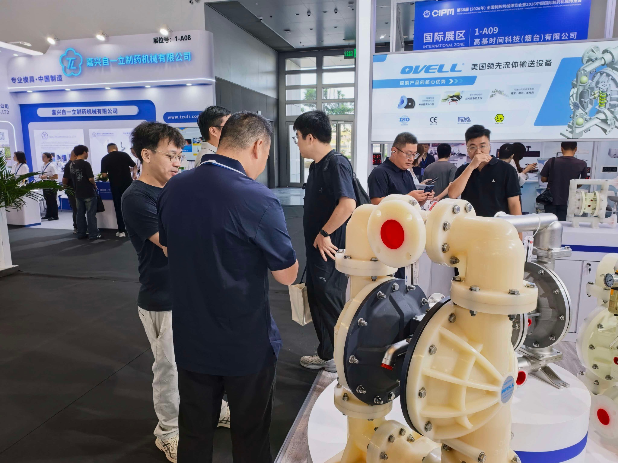 Visitors discussing an OVELL diaphragm pump at CIPM 2026