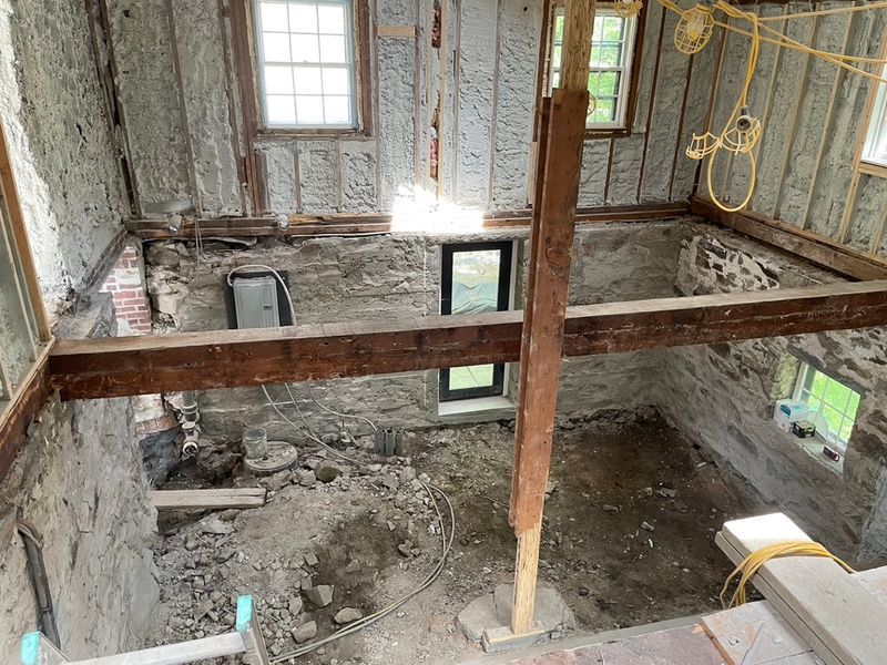 Interior of an older stone and timber building opened up to the studs during a restoration