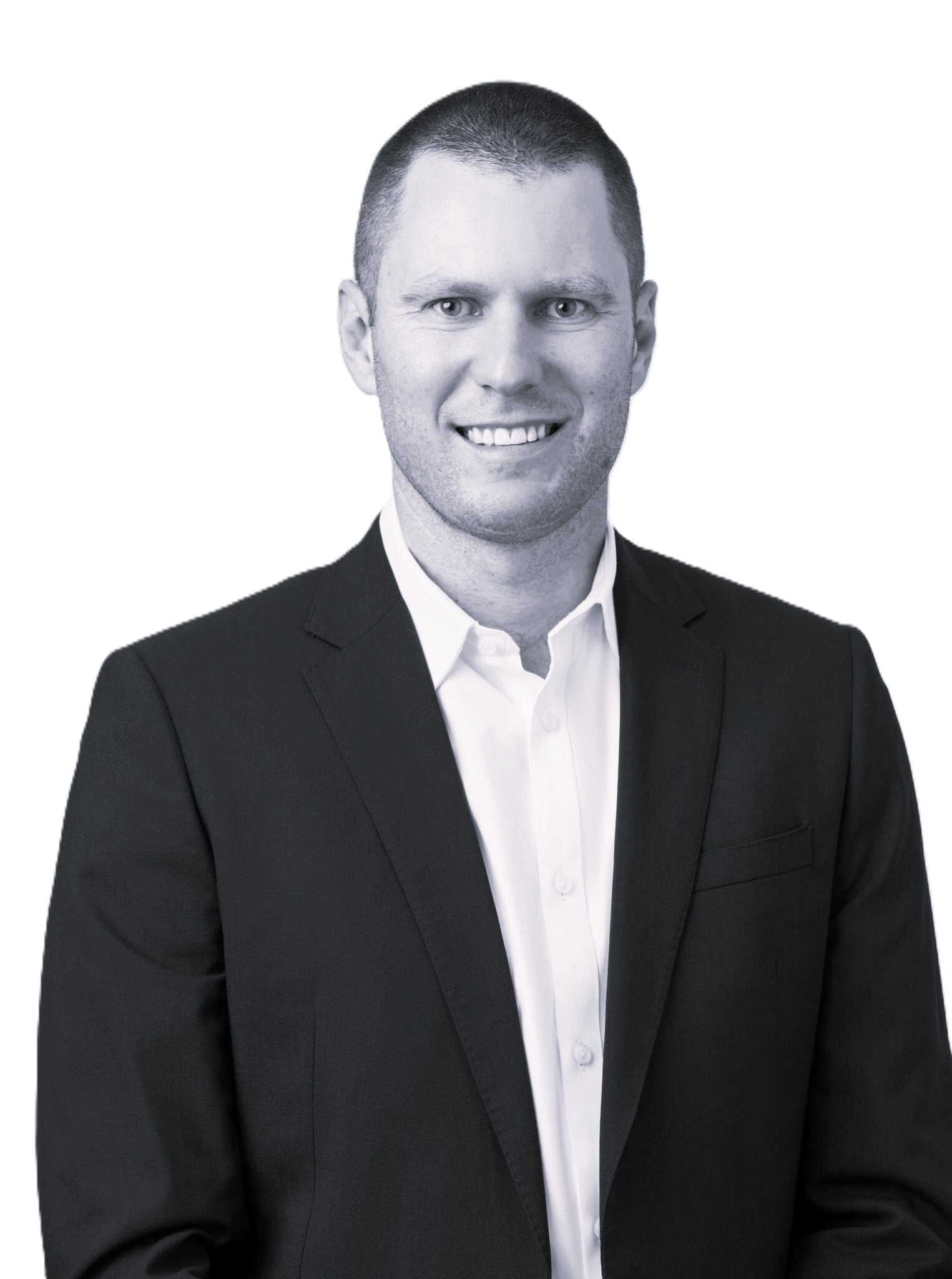 Smiling man with short hair wearing a black suit jacket and white dress shirt on a white background.