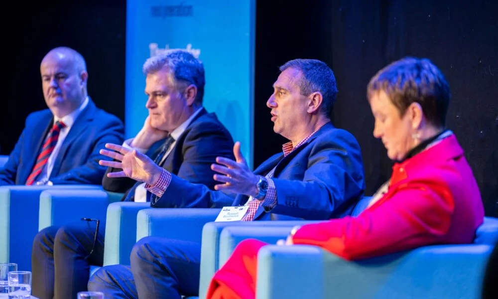Panel sitting on stage at an event