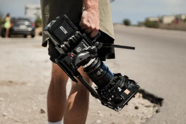 A person's hand holding a camera.