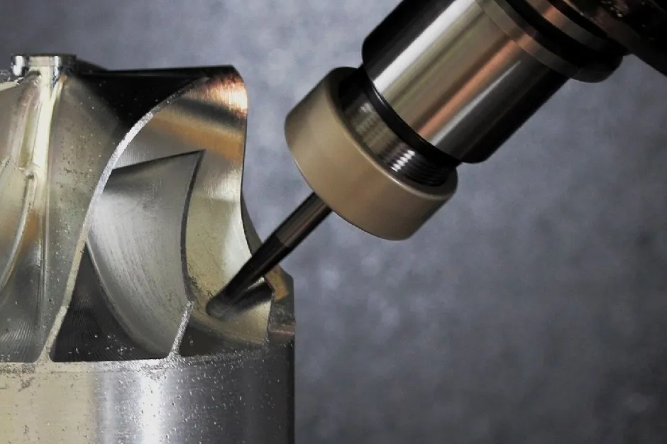 Metallic machine part being precisely machined with industrial cutting tool
