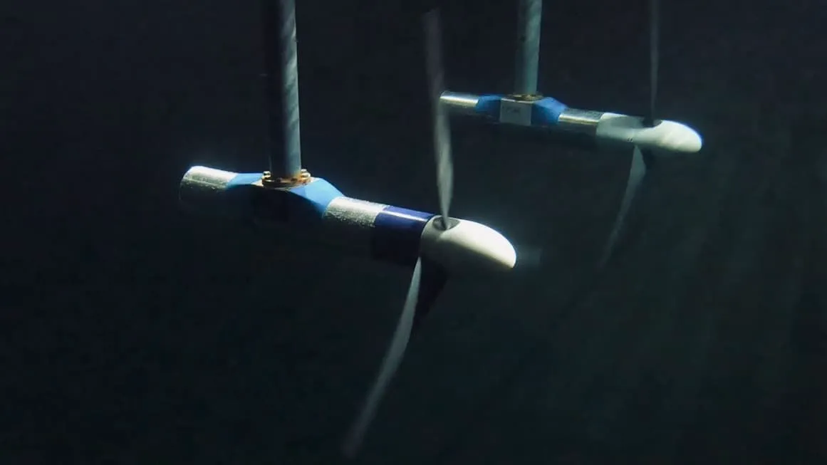 A group of blue and white pipes floating in the water