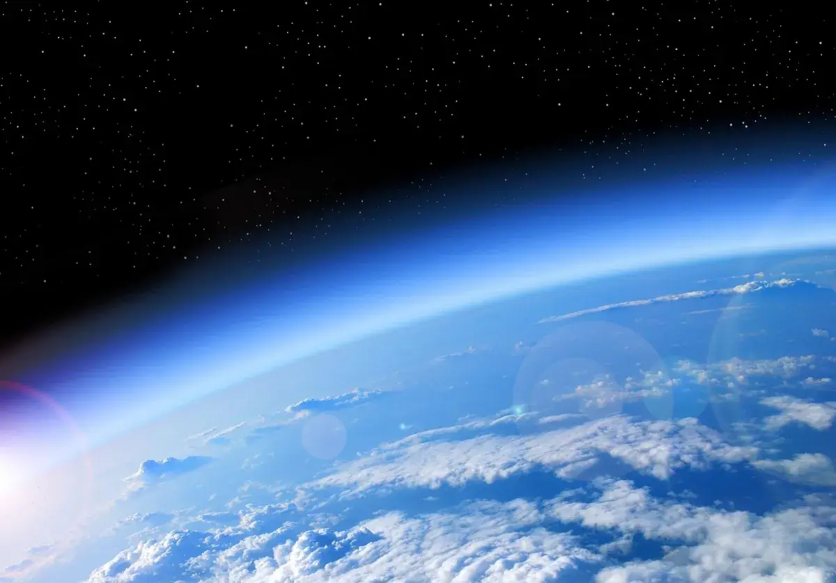 Earth's atmosphere and starry space, view from high above clouds