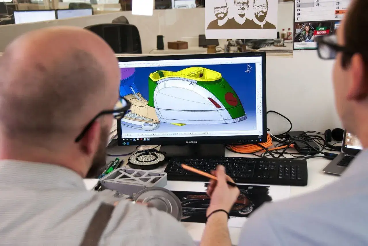 Two men looking at a computer.