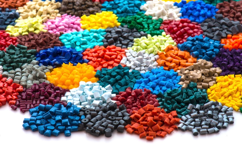 A pile of multicolored beads on a white surface