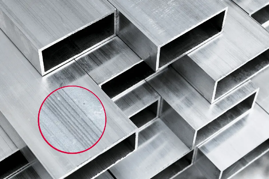 A pile of metal tubes with a red circle in the middle