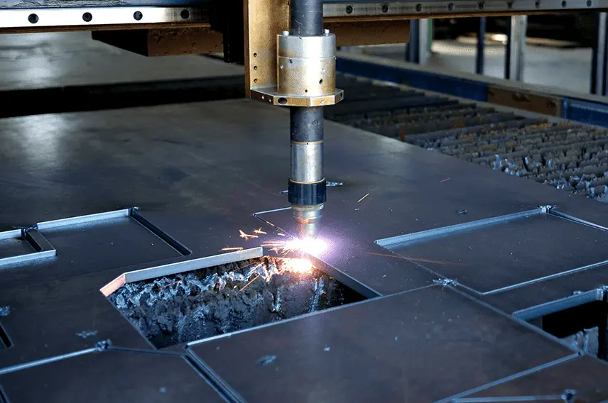 A machine cutting a piece of metal in a factory