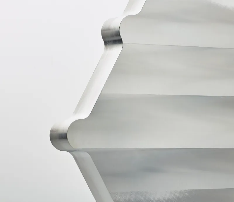 Metallic cube with multiple precision-machined cylindrical holes