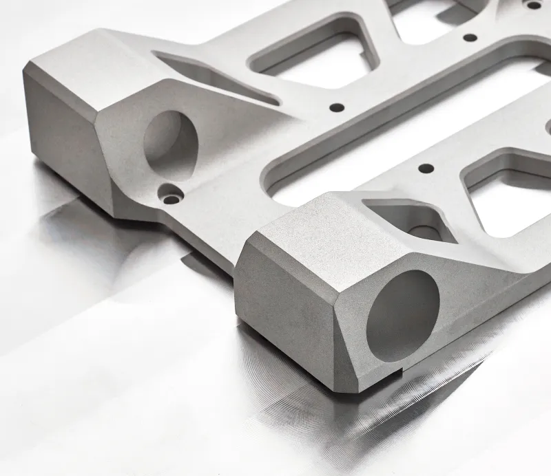 Metallic cube with precise machined holes and threaded openings