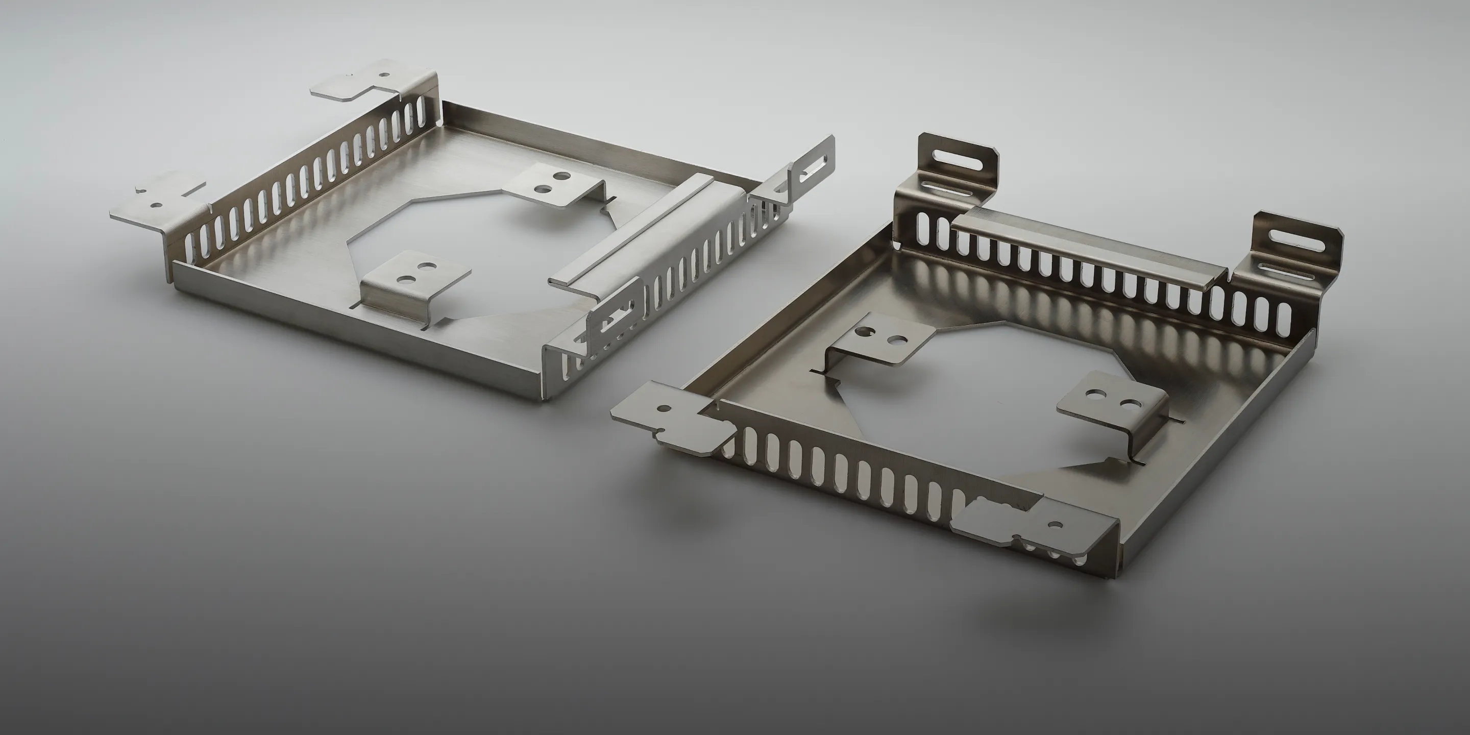 A pair of metal clips on a black background