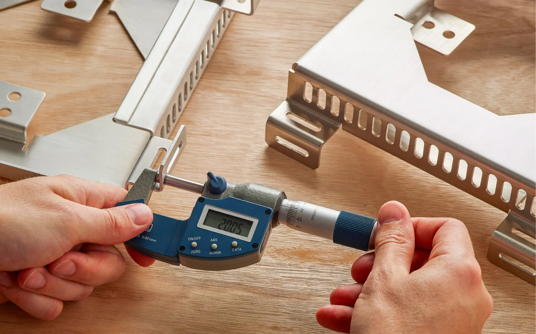 Industrial machine operator working on precision metal fabrication equipment