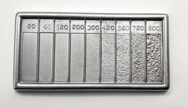 A metal plate with numbers explaining the roughness.