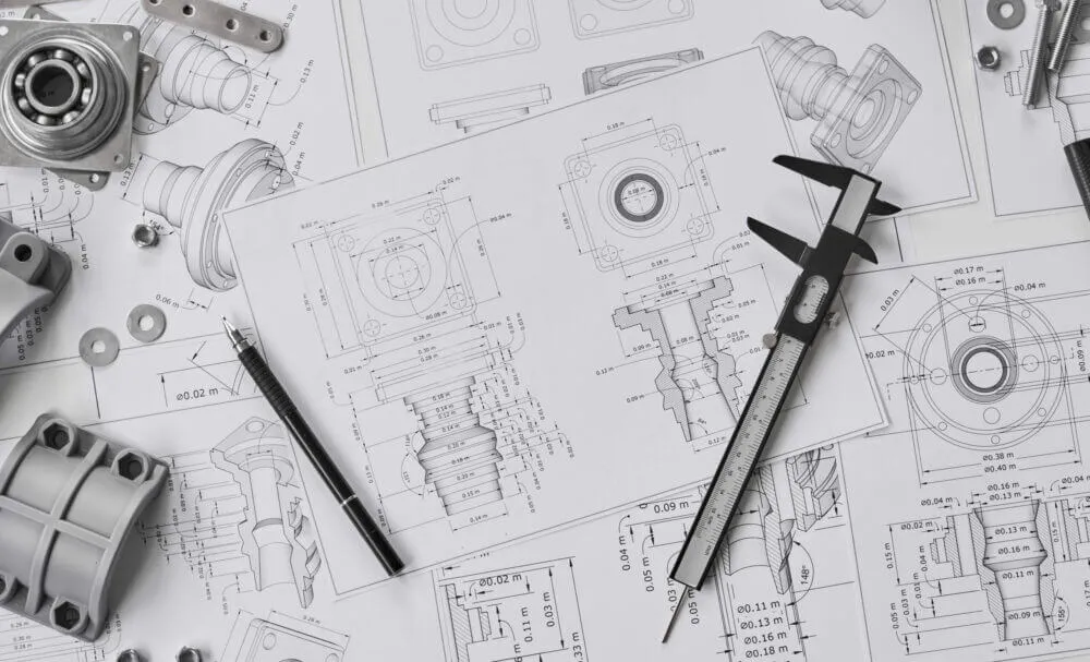 A calliper and pen on a paper.