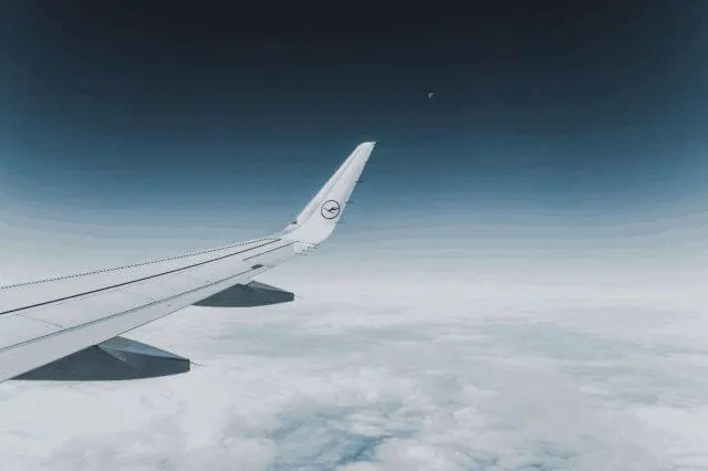 An airplane wing in the sky.