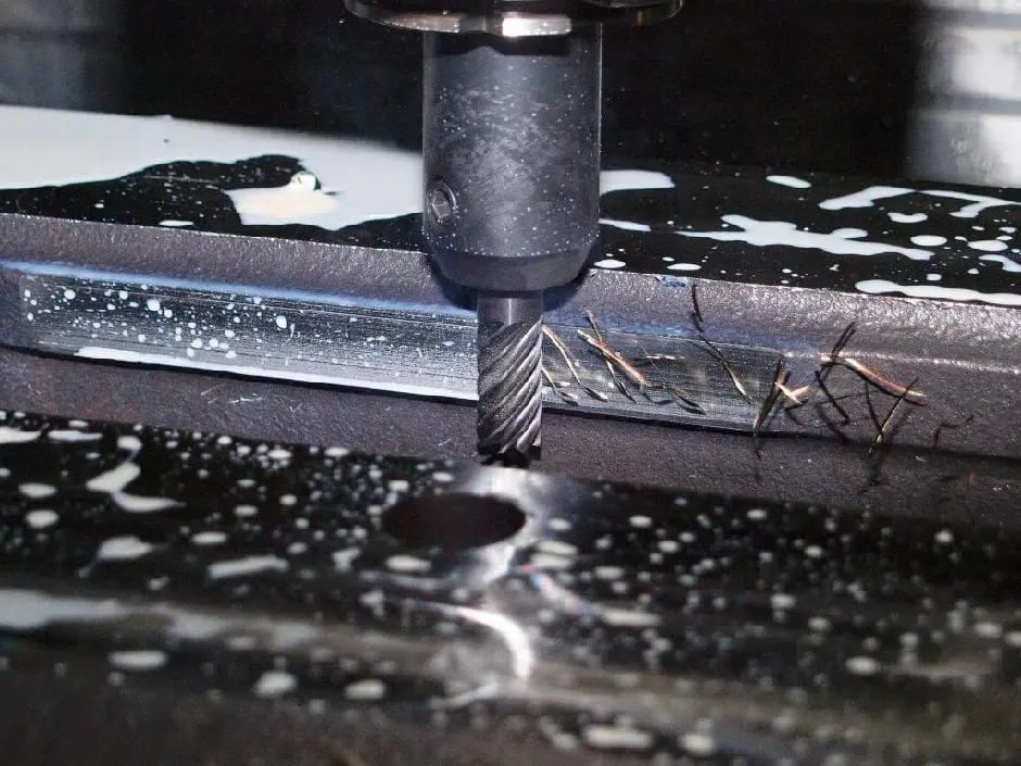 A milling machine cutting a piece of metal