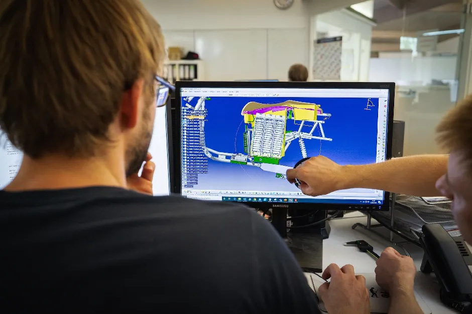 A man is pointing at a computer screen