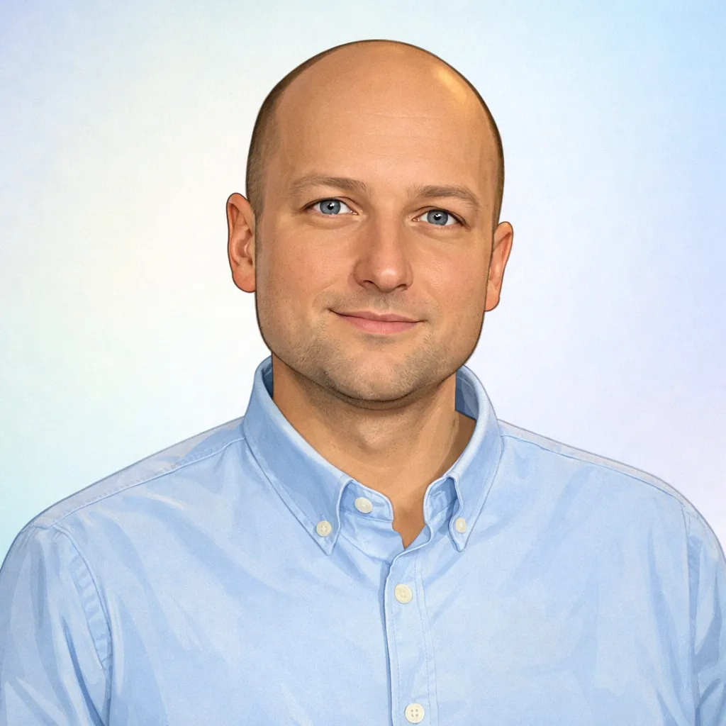 Dashly - Smiling bald man with blue eyes wearing a light blue buttoned shirt against a soft gradient background.