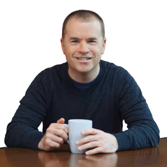 An image of Ian sitting at a table