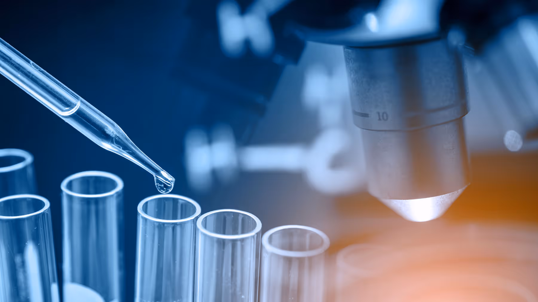 Dramatic microscope photo with test tubes and a pipette