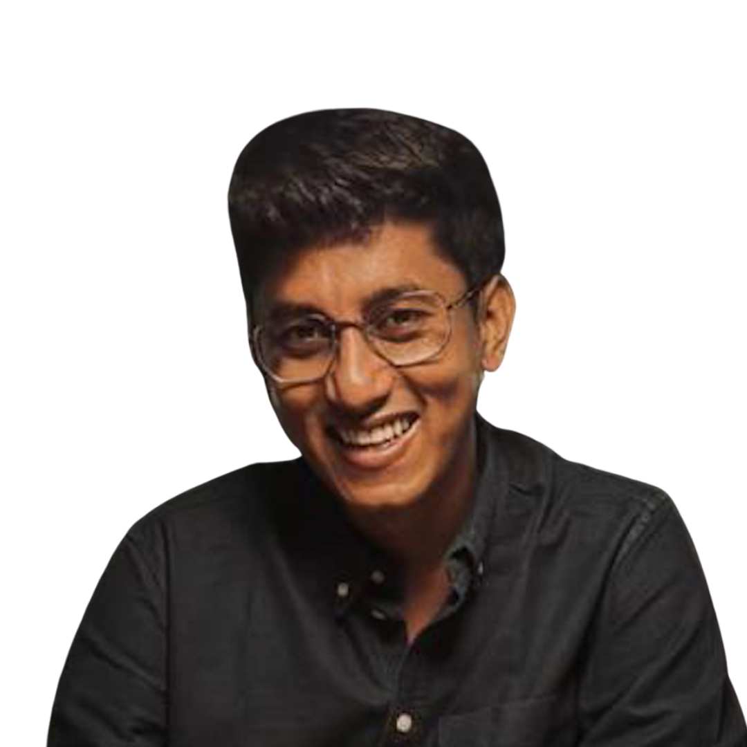 Young man with glasses smiling, wearing a dark button-up shirt against a transparent background.