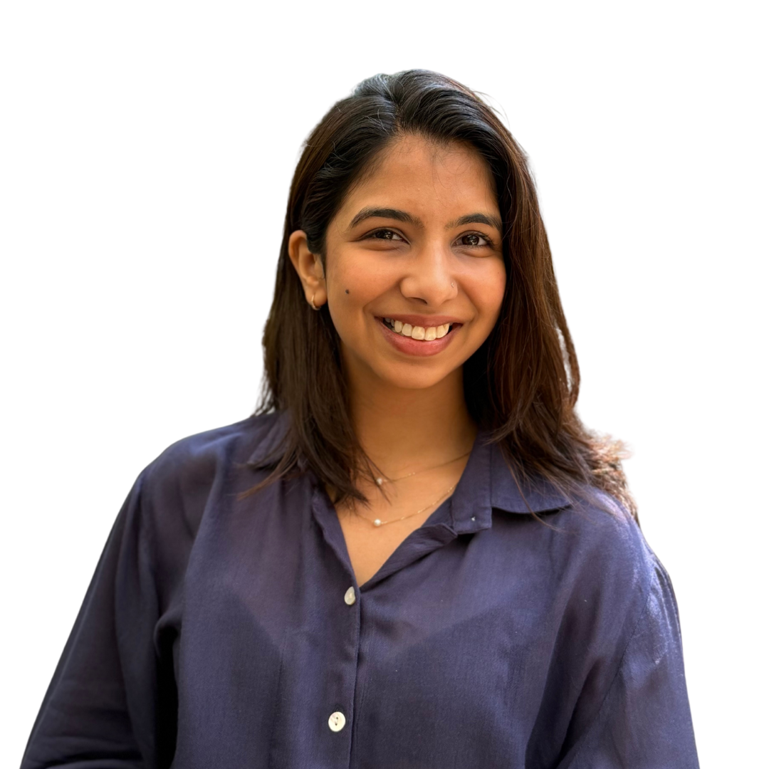 Smiling woman with medium-length dark hair wearing a dark blue buttoned shirt.