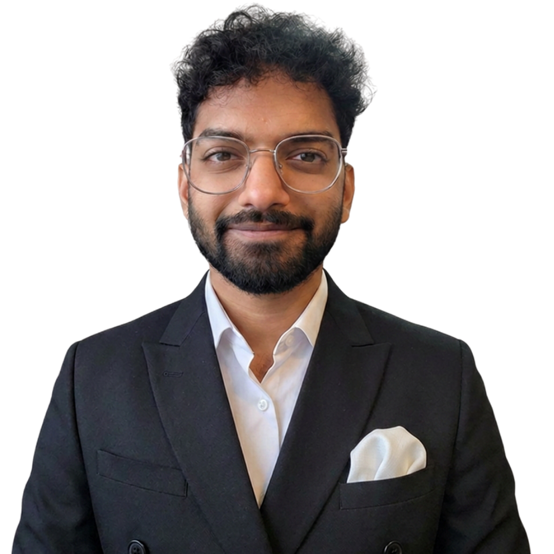 Man with glasses and beard wearing a black suit jacket with white shirt and pocket square.