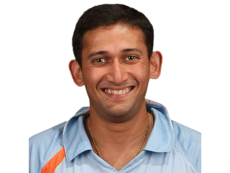 Smiling man wearing a light blue sports jersey with orange accents and a gold chain.