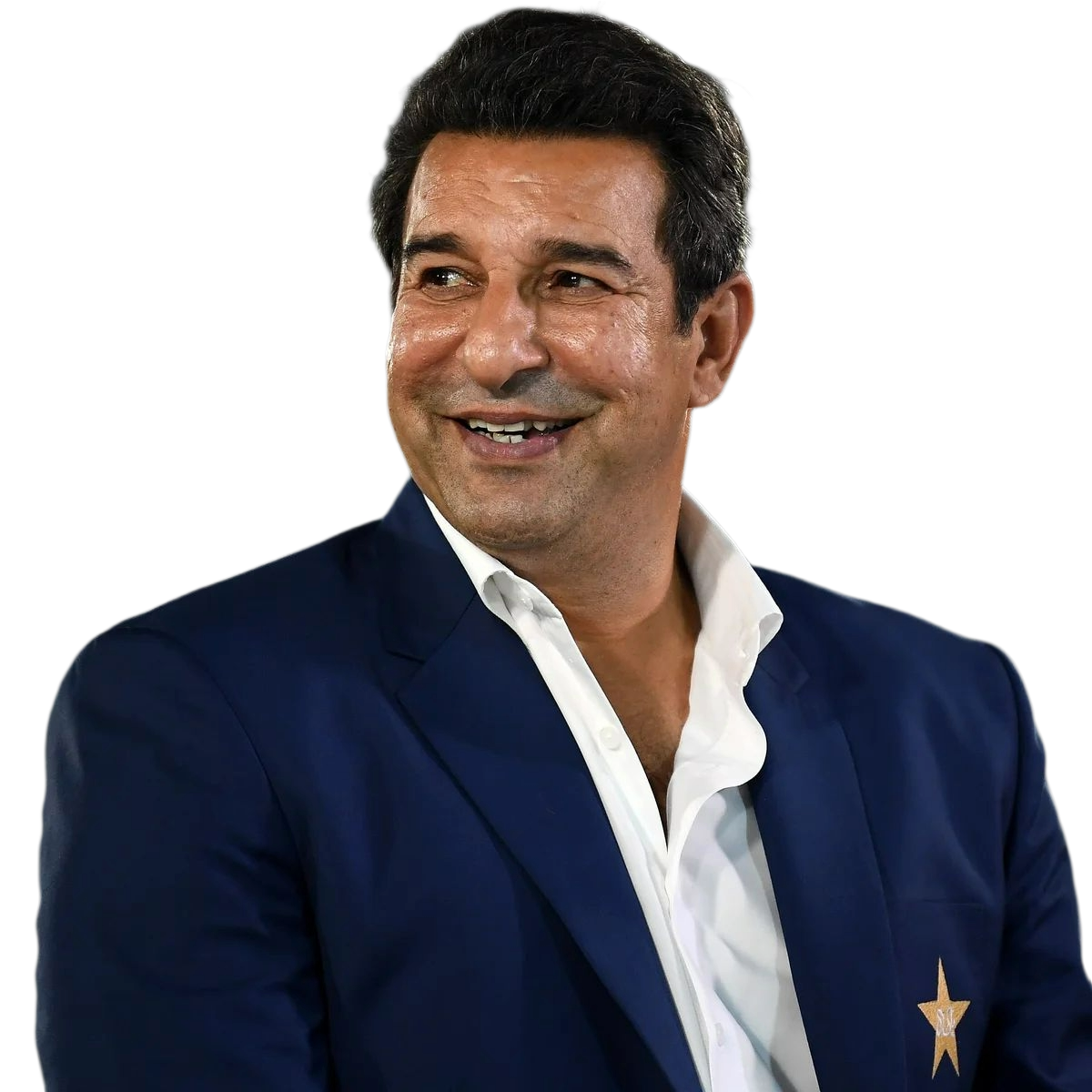 Smiling man in a blue blazer with a gold star emblem on the pocket, wearing a white shirt.