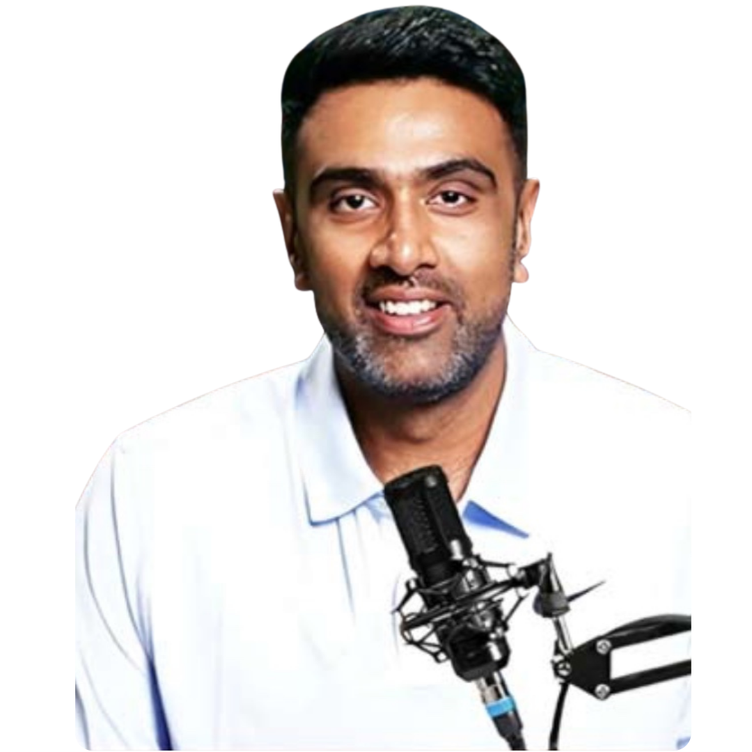 Smiling man with short black hair and facial stubble wearing a white collared shirt speaking into a black microphone on a boom arm.